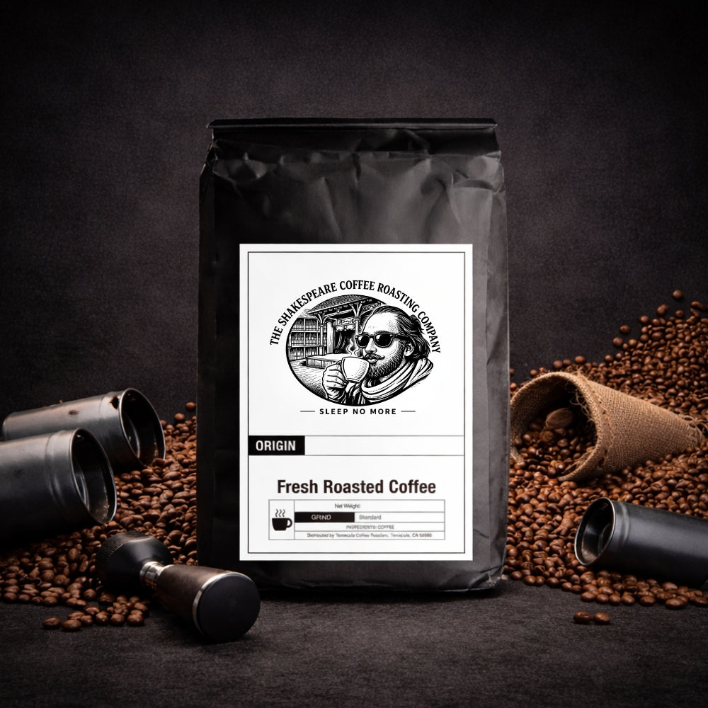 Black coffee bag with a shakespearean style label on a dark background with coffee beans and coffee grinders.